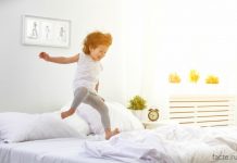 Ребенок прыгает на кровати